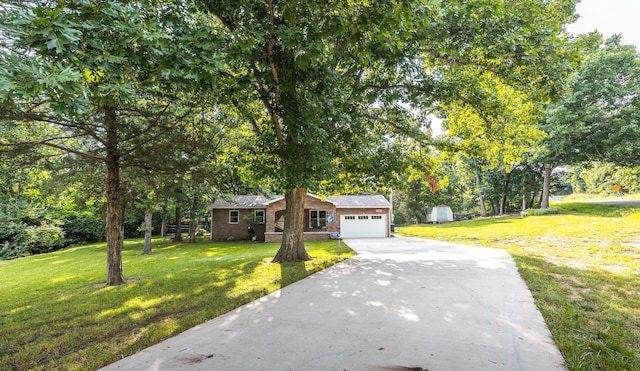 11240 State Hwy E, Rolla, MO 65401 - view of front of house featuring concrete driveway, an attached garage, a front yard, and brick siding