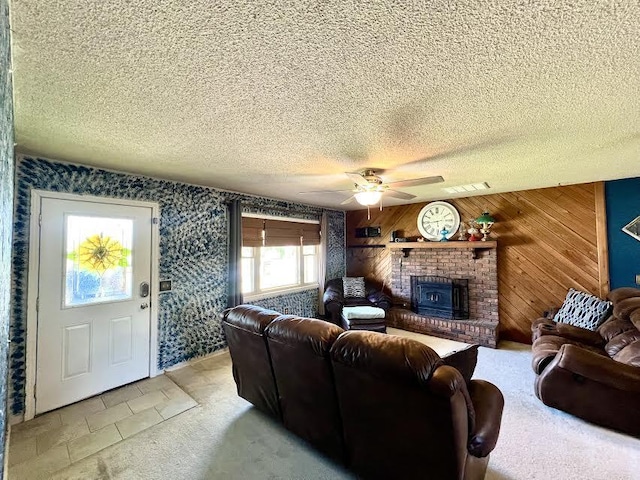 817 Fillmore St, Mount Vernon, MO 65712 - living room featuring a textured ceiling, a ceiling fan, a fireplace, and wood walls