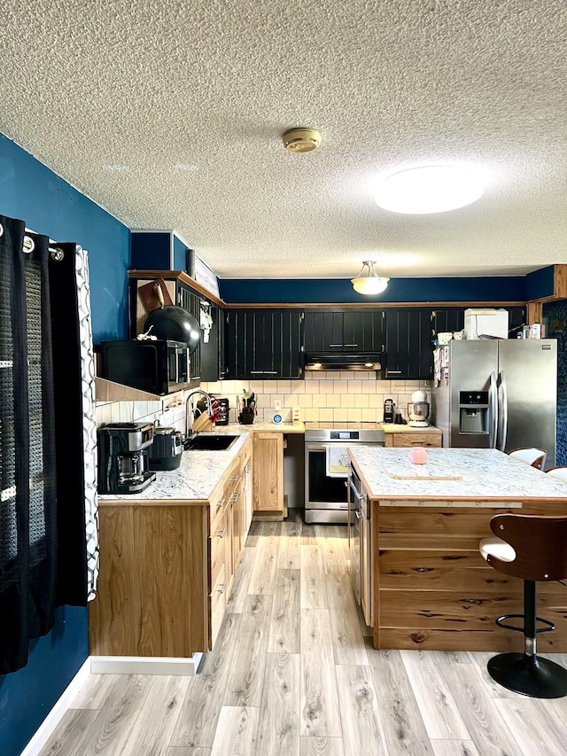 817 Fillmore St, Mount Vernon, MO 65712 - kitchen with stainless steel fridge, stove, light countertops, a textured ceiling, and light wood-style flooring