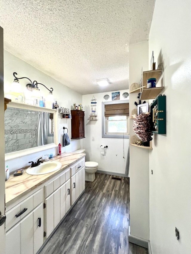 817 Fillmore St, Mount Vernon, MO 65712 - bathroom with a textured ceiling, wood finished floors, and vanity
