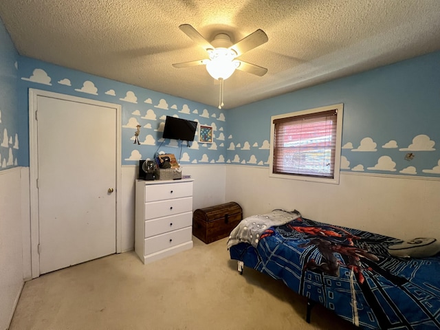 817 Fillmore St, Mount Vernon, MO 65712 - bedroom featuring wallpapered walls, a wainscoted wall, carpet flooring, a textured ceiling, and a ceiling fan