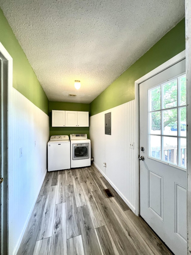 817 Fillmore St, Mount Vernon, MO 65712 - laundry area with electric panel, a textured ceiling, cabinet space, wood finished floors, and washer and clothes dryer
