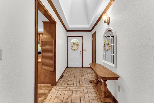 1011 W Tracy St, Springfield, MO 65807 - doorway with brick patterned flooring, a textured wall, and crown molding