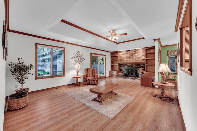1011 W Tracy St, Springfield, MO 65807 - living room with ceiling fan, plenty of natural light, a raised ceiling, light wood-style flooring, and ornamental molding