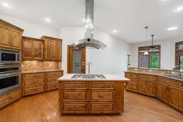744 Seven Pines Dr, Saddlebrooke, MO 65630 - kitchen with stainless steel appliances, wall chimney exhaust hood, brown cabinetry, light wood-style floors, and recessed lighting