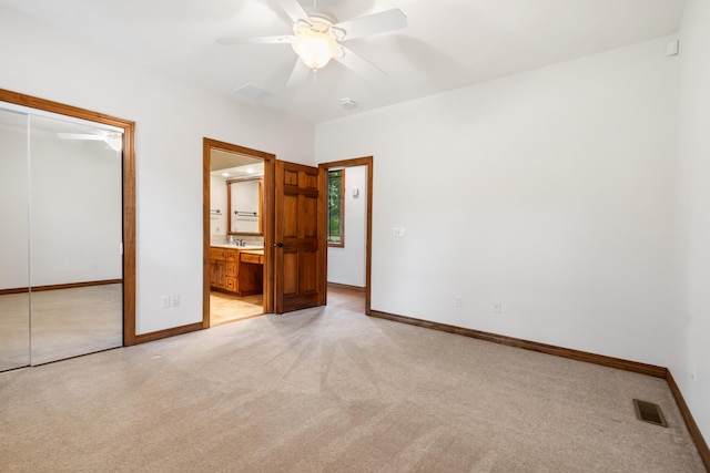 744 Seven Pines Dr, Saddlebrooke, MO 65630 - unfurnished bedroom with light colored carpet, a closet, a ceiling fan, and connected bathroom