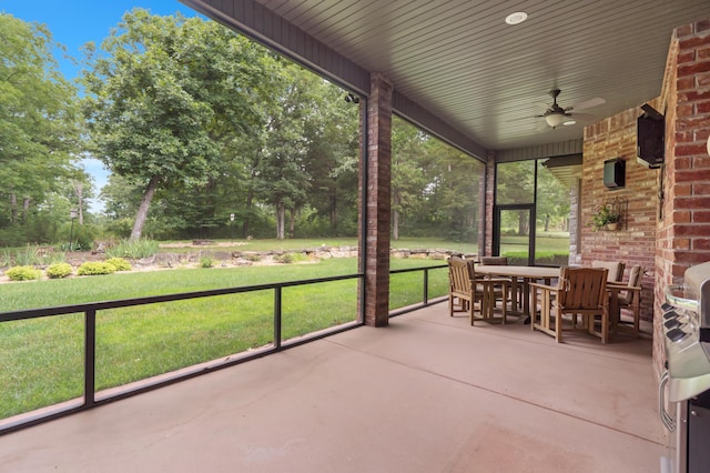 744 Seven Pines Dr, Saddlebrooke, MO 65630 - view of patio featuring a ceiling fan, outdoor dining space, and view of scattered trees