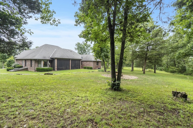 744 Seven Pines Dr, Saddlebrooke, MO 65630 - view of grassy yard with a sunroom and a garage