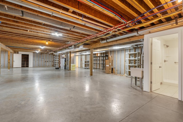 744 Seven Pines Dr, Saddlebrooke, MO 65630 - unfinished basement with water heater and a sink