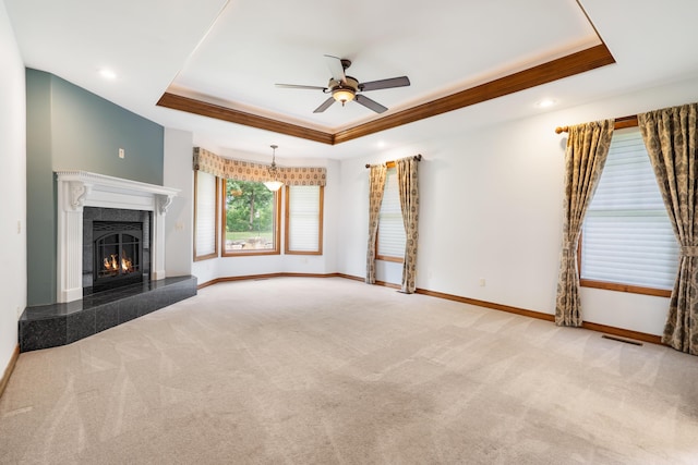 744 Seven Pines Dr, Saddlebrooke, MO 65630 - unfurnished living room with a raised ceiling, ceiling fan, carpet floors, a tiled fireplace, and ornamental molding