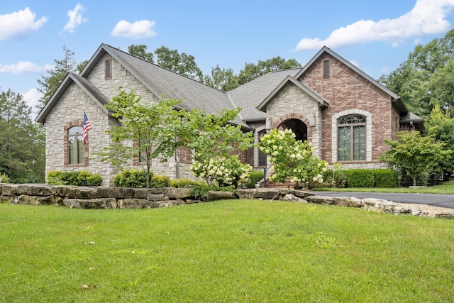 744 Seven Pines Dr, Saddlebrooke, MO 65630 - french provincial home with stone siding, brick siding, a front lawn, and a shingled roof