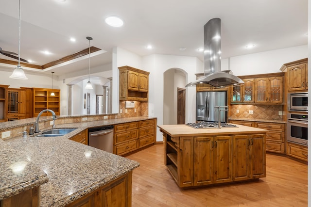 744 Seven Pines Dr, Saddlebrooke, MO 65630 - kitchen featuring stainless steel appliances, island exhaust hood, an island with sink, arched walkways, and tasteful backsplash