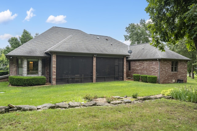 744 Seven Pines Dr, Saddlebrooke, MO 65630 - rear view of house featuring a lawn, a sunroom, a shingled roof, and brick siding