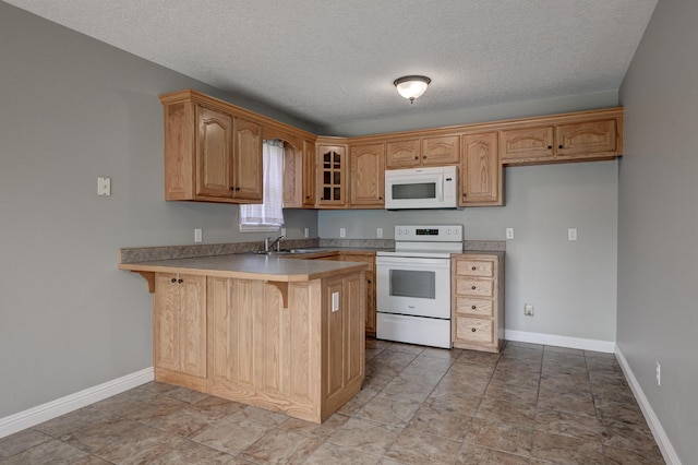 4406 W 28th St, Joplin, MO 64804 - kitchen with white appliances, a peninsula, a kitchen bar, glass insert cabinets, and light countertops