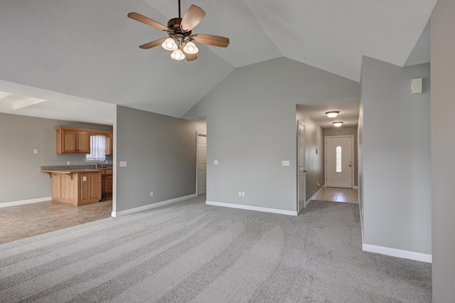 4406 W 28th St, Joplin, MO 64804 - unfurnished living room featuring light carpet, ceiling fan, and lofted ceiling