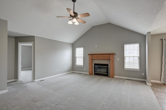 4406 W 28th St, Joplin, MO 64804 - unfurnished living room with a fireplace, ceiling fan, vaulted ceiling, and light colored carpet