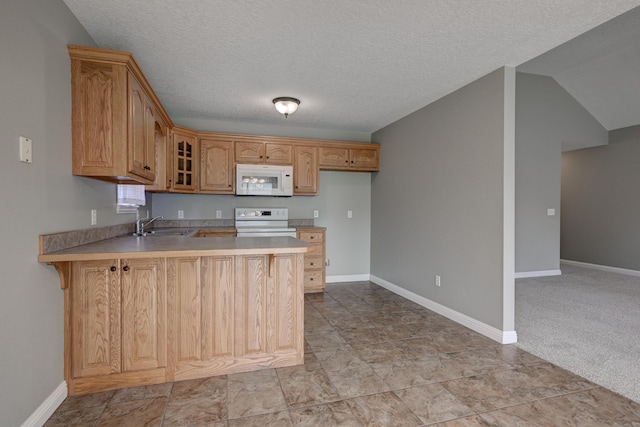 4406 W 28th St, Joplin, MO 64804 - kitchen featuring white appliances, a peninsula, light countertops, glass insert cabinets, and a textured ceiling