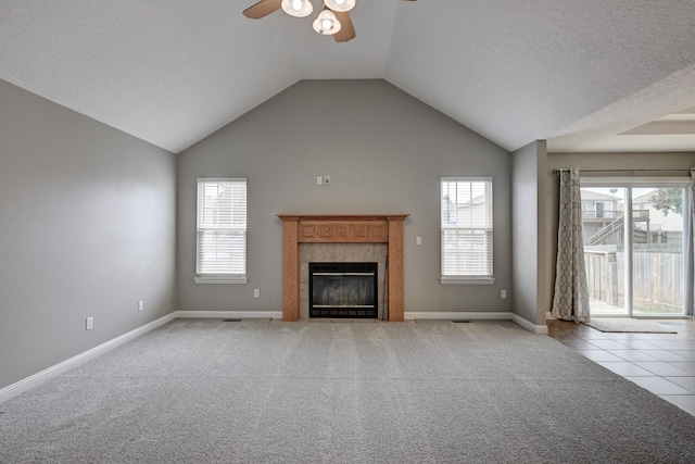 4406 W 28th St, Joplin, MO 64804 - unfurnished living room with a ceiling fan, plenty of natural light, a fireplace, carpet floors, and high vaulted ceiling