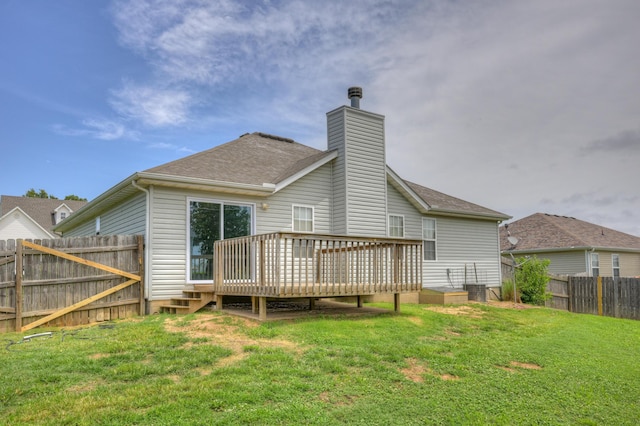 4406 W 28th St, Joplin, MO 64804 - rear view of house featuring a chimney, a fenced backyard, a wooden deck, and roof with shingles