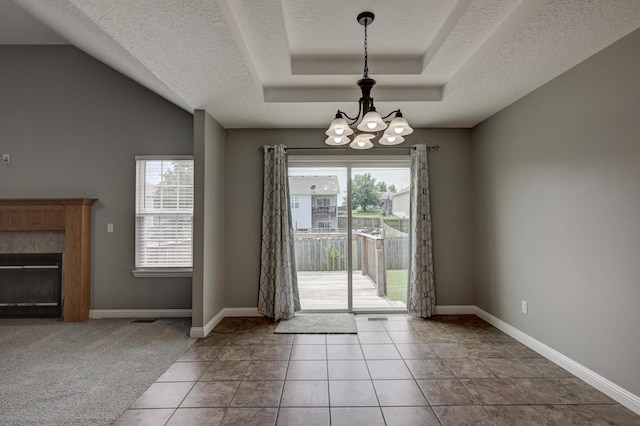 4406 W 28th St, Joplin, MO 64804 - doorway featuring a chandelier, a textured ceiling, a fireplace, and tile patterned flooring
