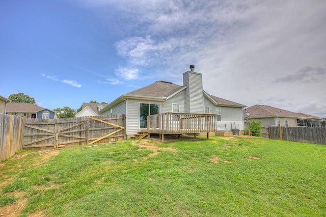4406 W 28th St, Joplin, MO 64804 - rear view of house featuring a chimney, a wooden deck, and a fenced backyard