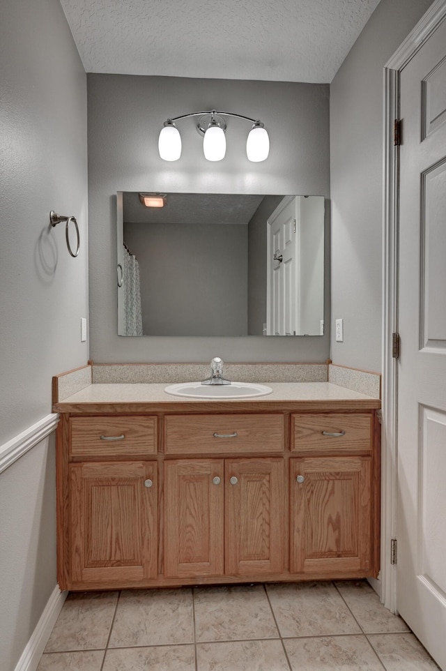 4406 W 28th St, Joplin, MO 64804 - full bath with vanity, tile patterned flooring, and a textured ceiling