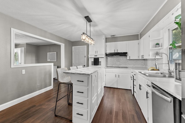 522 S Belcrest Ave, Springfield, MO 65802 - kitchen featuring stainless steel dishwasher, white oven, black electric stovetop, under cabinet range hood, and a center island