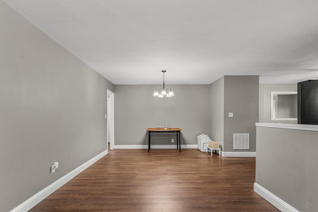 522 S Belcrest Ave, Springfield, MO 65802 - unfurnished room with dark wood finished floors and a chandelier