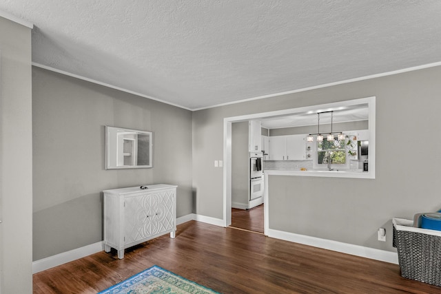 522 S Belcrest Ave, Springfield, MO 65802 - unfurnished room featuring dark wood-style floors, a textured ceiling, and crown molding