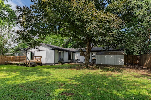 522 S Belcrest Ave, Springfield, MO 65802 - back of house with a deck, a fenced backyard, and a storage shed