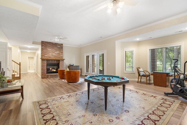 3314 Winged Foot Dr, Nixa, MO 65714 - rec room with a ceiling fan, wood finished floors, a fireplace, and ornamental molding