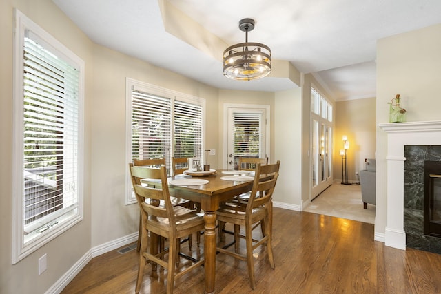 3314 Winged Foot Dr, Nixa, MO 65714 - dining area featuring wood finished floors, french doors, a chandelier, and a fireplace