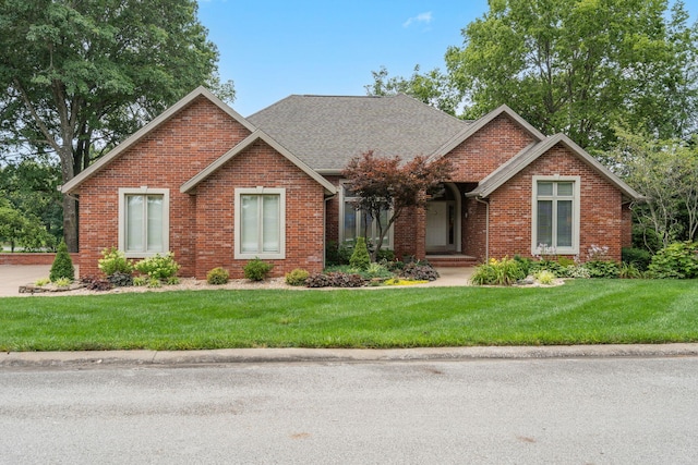 3314 Winged Foot Dr, Nixa, MO 65714 - view of front of home with brick siding, a front lawn, and a shingled roof