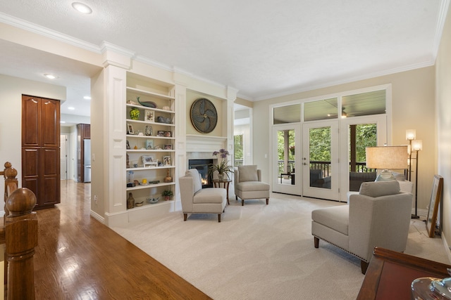 3314 Winged Foot Dr, Nixa, MO 65714 - living area featuring ornamental molding, a glass covered fireplace, built in shelves, light wood-type flooring, and recessed lighting