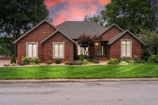 3314 Winged Foot Dr, Nixa, MO 65714 - view of front facade featuring brick siding, a front lawn, and a shingled roof