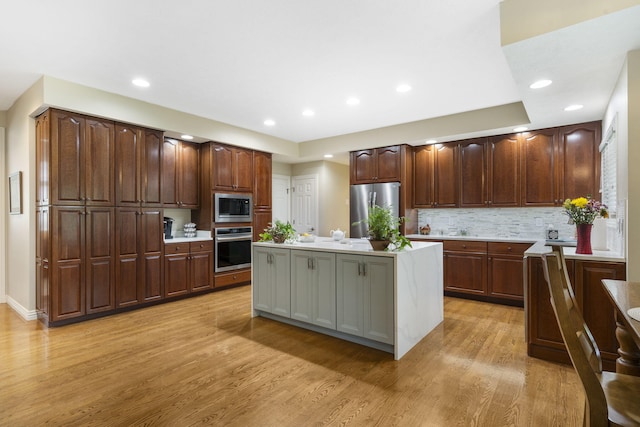 3314 Winged Foot Dr, Nixa, MO 65714 - kitchen featuring appliances with stainless steel finishes, light wood-style floors, light countertops, recessed lighting, and a center island