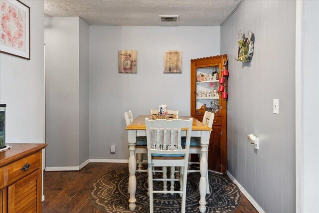 1188 Emerald Rd, Spokane, MO 65754 - dining room with dark wood finished floors and a textured ceiling