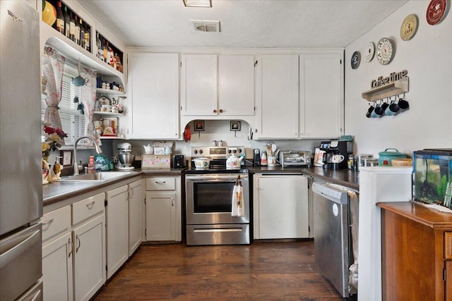 1188 Emerald Rd, Spokane, MO 65754 - kitchen with stainless steel appliances, open shelves, dark wood finished floors, and white cabinetry
