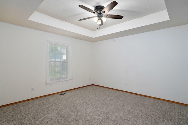 2816 N Pierce Ave, Springfield, MO 65803 - carpeted spare room with a raised ceiling and a ceiling fan