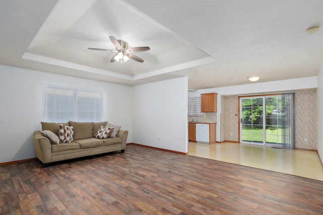 2816 N Pierce Ave, Springfield, MO 65803 - living area featuring a tray ceiling, light wood-style floors, and a ceiling fan