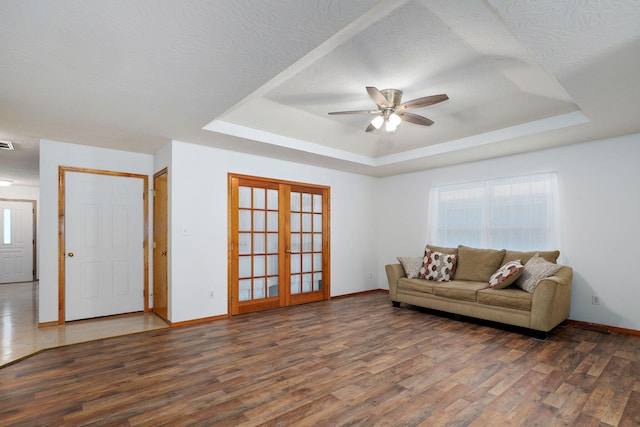 2816 N Pierce Ave, Springfield, MO 65803 - living area with wood finished floors, a raised ceiling, ceiling fan, and french doors
