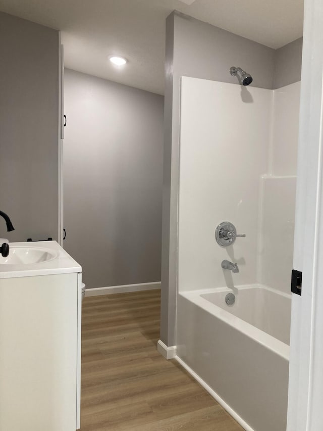 507 W Clouse St, Mountain Grove, MO 65711 - bathroom with shower / washtub combination, wood finished floors, vanity, and recessed lighting