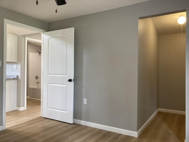 507 W Clouse St, Mountain Grove, MO 65711 - unfurnished bedroom with wood finished floors and ceiling fan