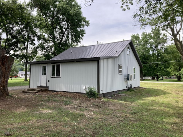 507 W Clouse St, Mountain Grove, MO 65711 - view of side of home with a metal roof, a lawn, and cooling unit