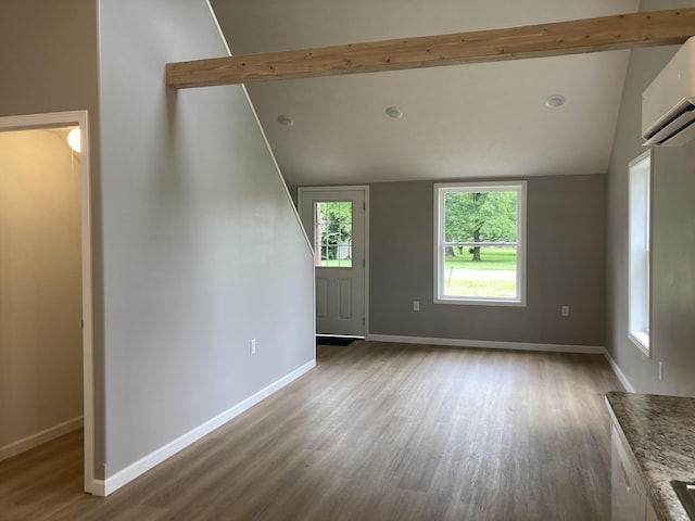 507 W Clouse St, Mountain Grove, MO 65711 - unfurnished living room featuring wood finished floors and a wall mounted air conditioner