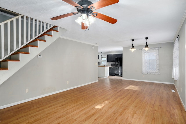 533 N Main St, Republic, MO 65738 - unfurnished living room with ornamental molding, light wood finished floors, ceiling fan, and stairway