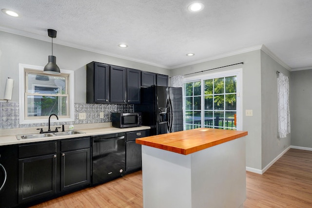 533 N Main St, Republic, MO 65738 - kitchen with black appliances, butcher block counters, light wood-style flooring, decorative backsplash, and pendant lighting
