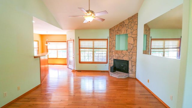 5546 S Aspen Dr, Battlefield, MO 65619 - unfurnished living room featuring wood finished floors, a ceiling fan, a fireplace, and high vaulted ceiling