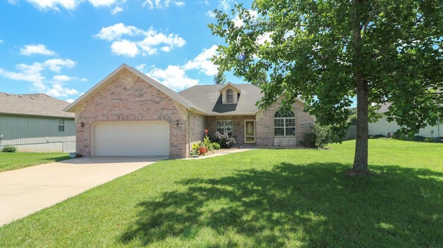 5546 S Aspen Dr, Battlefield, MO 65619 - view of front of house featuring brick siding, an attached garage, a front lawn, and driveway