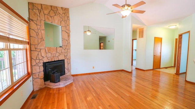 5546 S Aspen Dr, Battlefield, MO 65619 - unfurnished living room with a ceiling fan, vaulted ceiling, hardwood / wood-style floors, healthy amount of natural light, and a wood stove